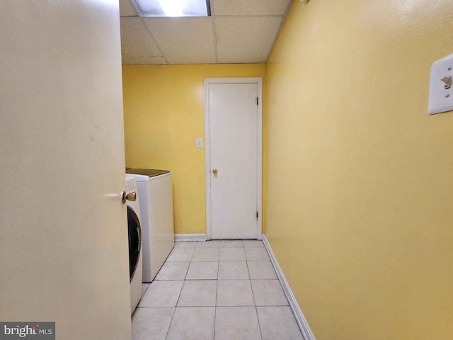 washroom featuring washer and clothes dryer and light tile patterned flooring