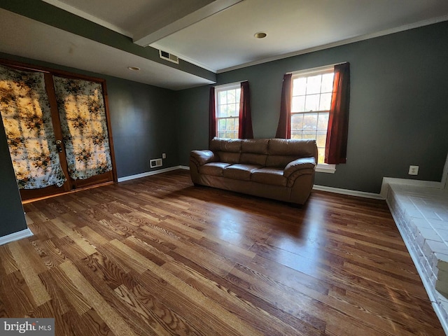 unfurnished living room with ornamental molding, hardwood / wood-style floors, and beamed ceiling