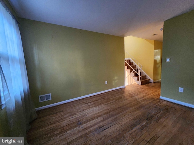 unfurnished room with wood-type flooring