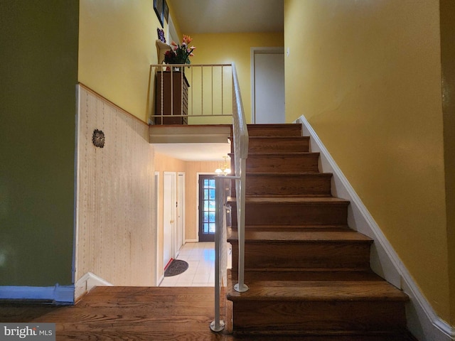 staircase with a chandelier