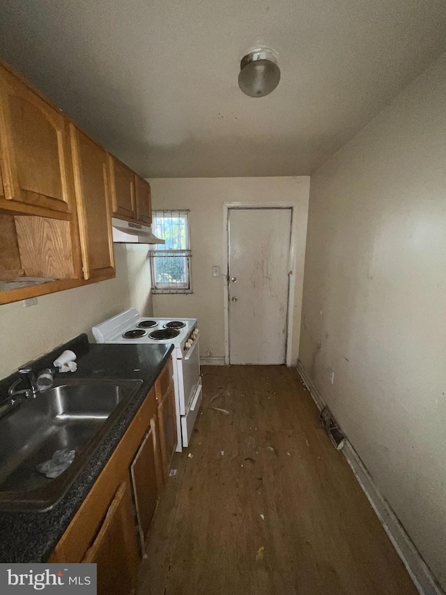 1745 W Seybert St, Philadelphia, PA 19121 - kitchen featuring under cabinet range hood, white range with electric cooktop, dark wood-style flooring, a sink, and brown cabinets