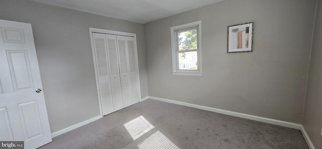 unfurnished bedroom with carpet floors and a closet