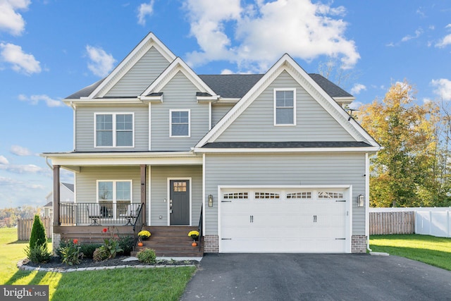 craftsman-style house featuring a porch, a front lawn, and a garage