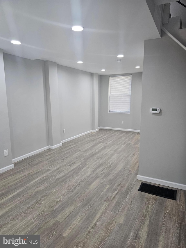 basement with hardwood / wood-style floors