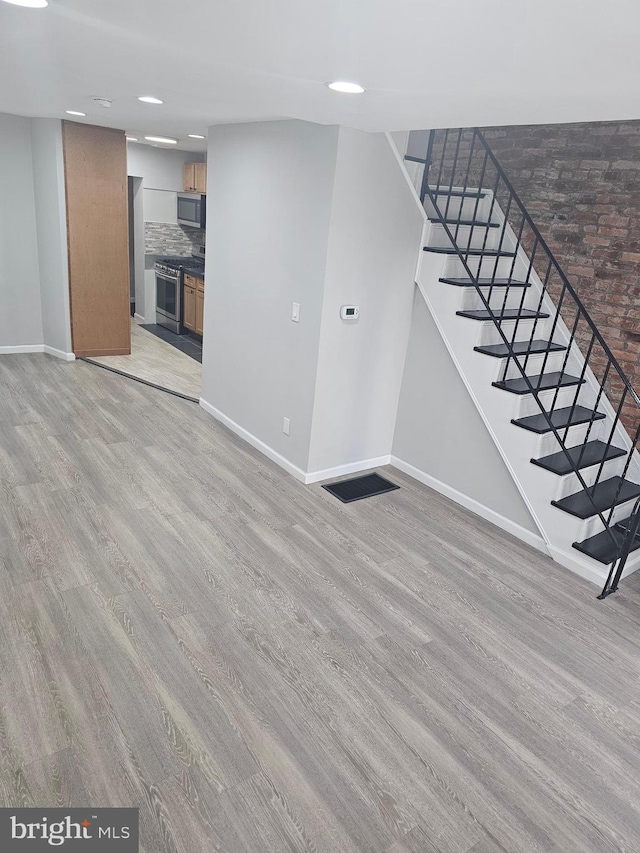 unfurnished living room featuring light wood-type flooring