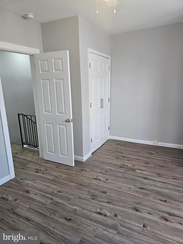 empty room with dark hardwood / wood-style flooring