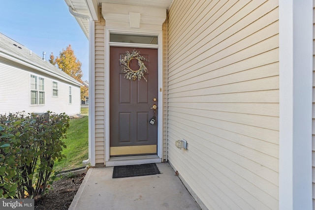 entrance to property with a lawn