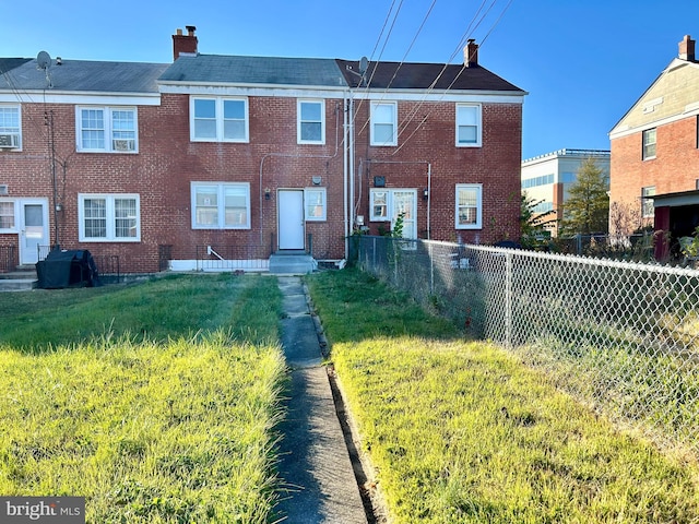 back of house with a lawn