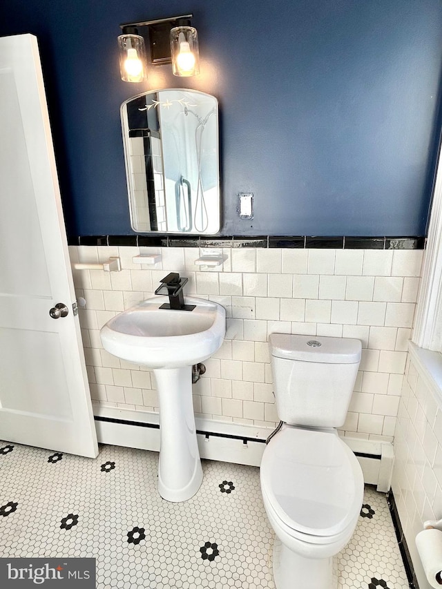 bathroom featuring toilet, tile walls, and tile patterned floors