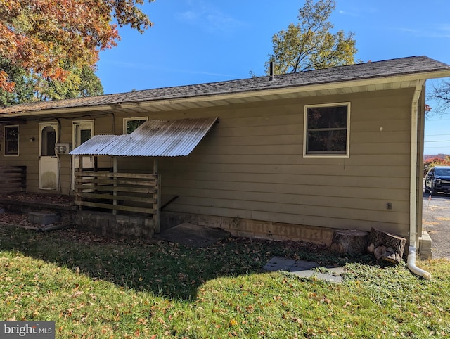 rear view of house featuring a yard