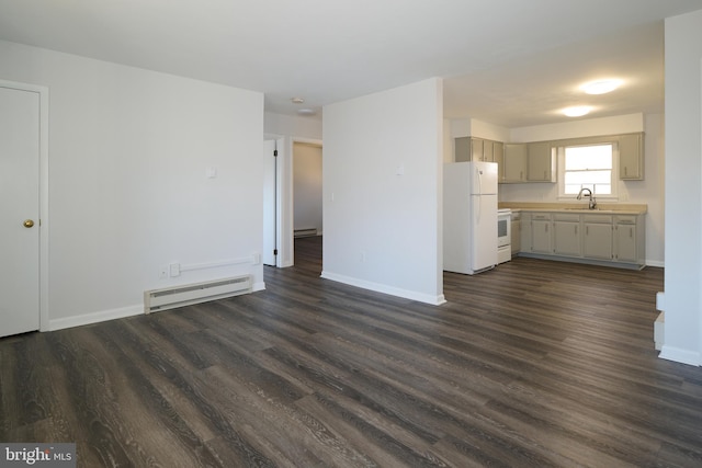 unfurnished living room with sink, a baseboard radiator, and dark hardwood / wood-style floors