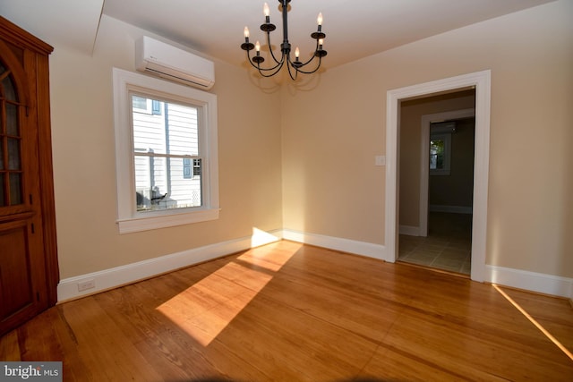 unfurnished dining area with an AC wall unit, an inviting chandelier, and hardwood / wood-style floors