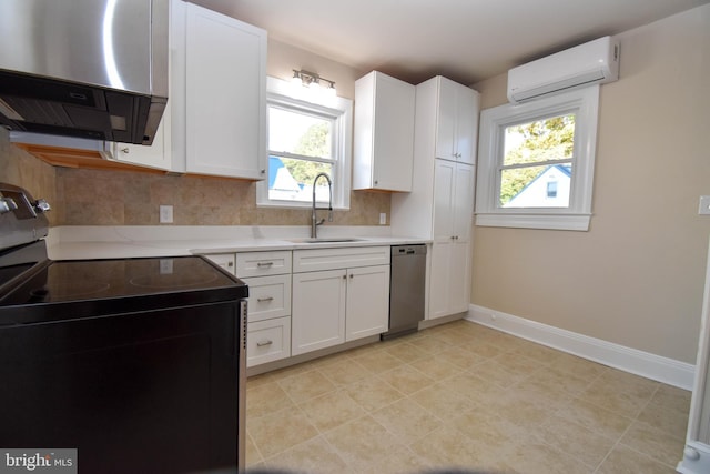 kitchen featuring a wall mounted AC, stainless steel appliances, a wealth of natural light, sink, and white cabinets