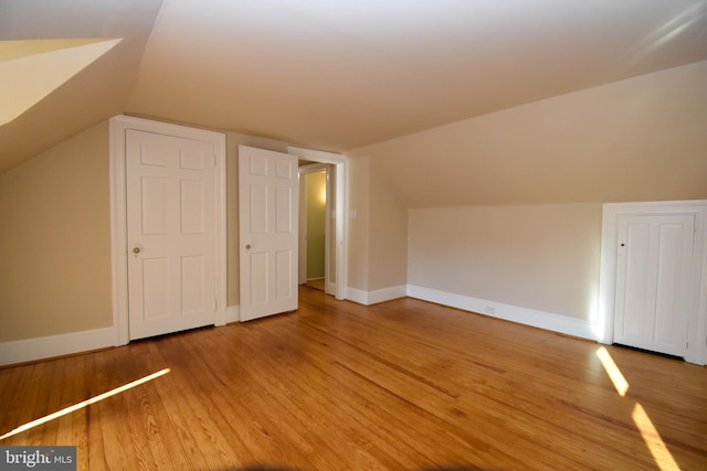 bonus room featuring lofted ceiling and hardwood / wood-style floors