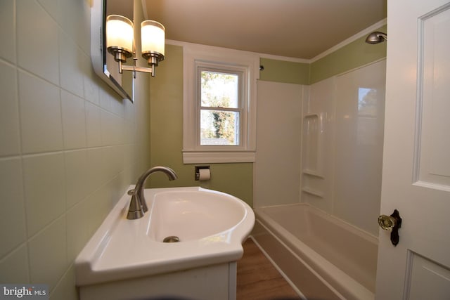 bathroom featuring shower / bath combination, tile walls, vanity, crown molding, and hardwood / wood-style flooring