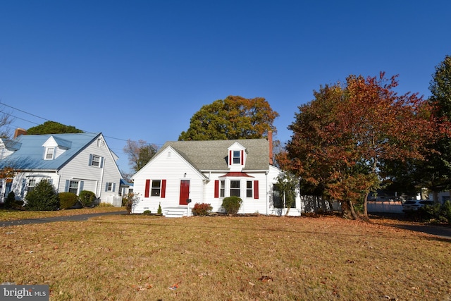 cape cod house with a front lawn