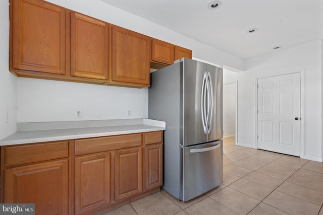 kitchen with stainless steel refrigerator and light tile patterned flooring