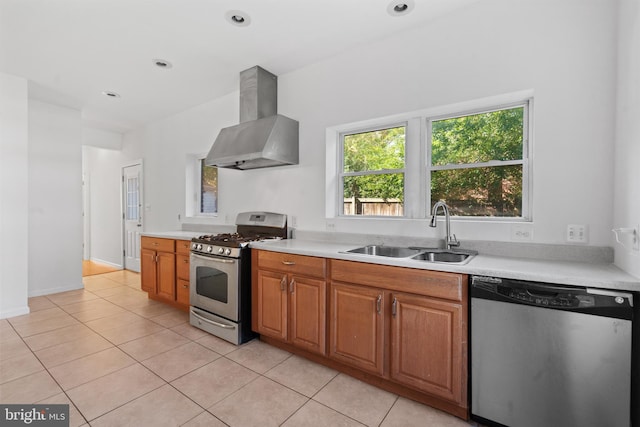 kitchen featuring sink, appliances with stainless steel finishes, range hood, and light tile patterned floors