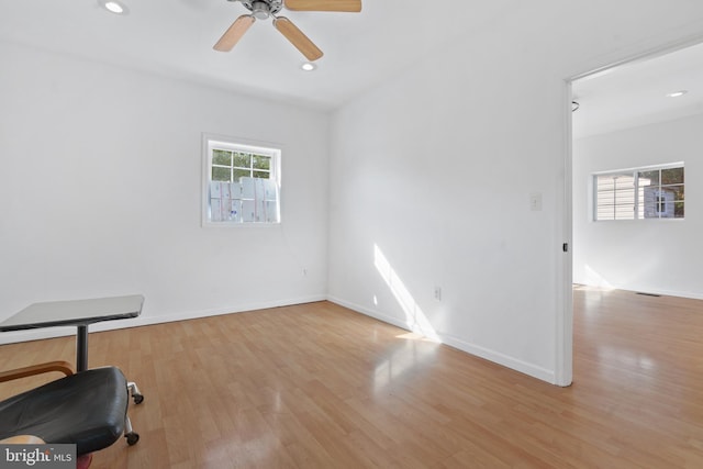 empty room with light wood-type flooring and ceiling fan