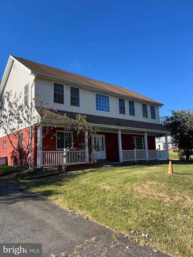 view of front of property with covered porch and a front yard