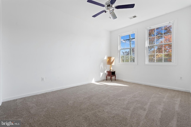 spare room with carpet floors and ceiling fan