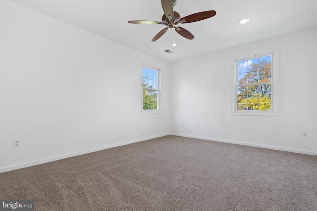 empty room with ceiling fan and carpet floors