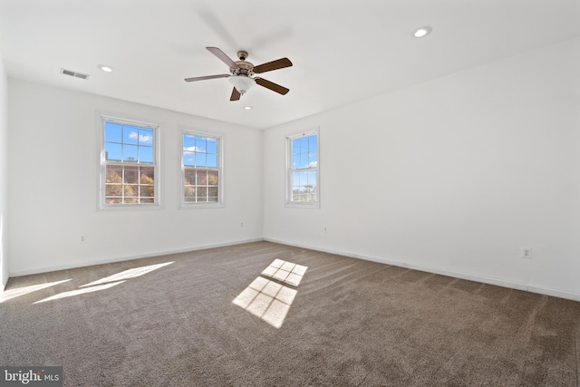 carpeted spare room with ceiling fan