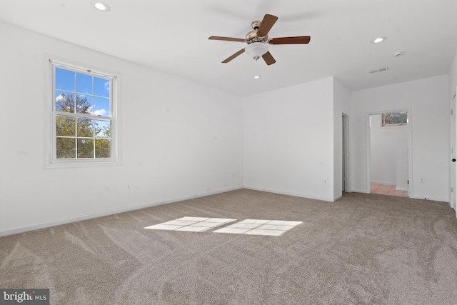 spare room with light carpet and ceiling fan