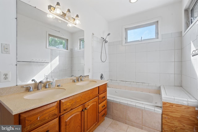 bathroom featuring a wealth of natural light, vanity, tiled shower / bath combo, and tile patterned flooring