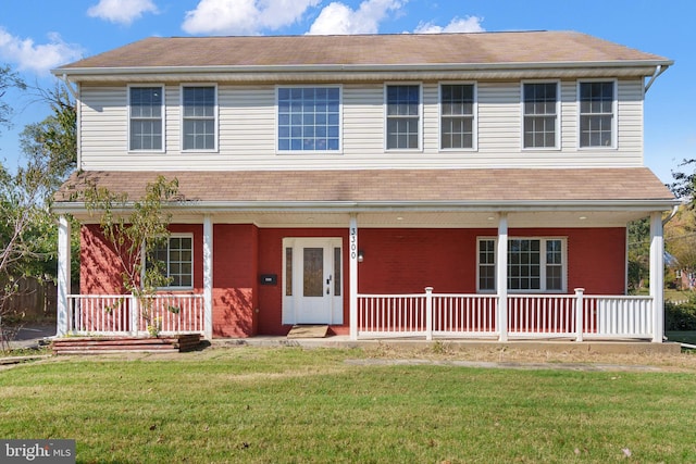 view of front of home with a porch and a front lawn