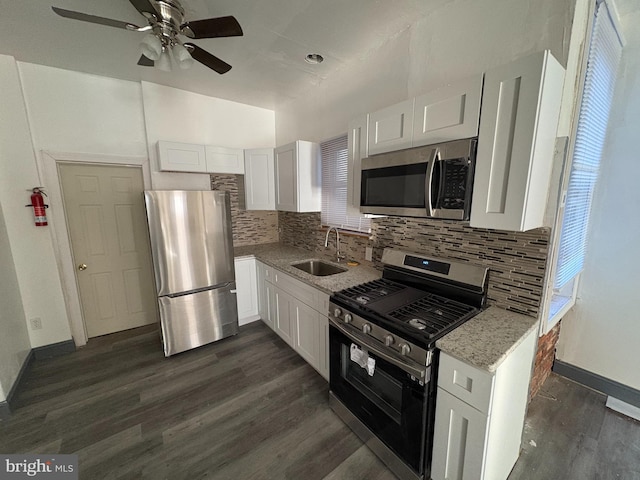 kitchen featuring white cabinetry, appliances with stainless steel finishes, sink, and dark hardwood / wood-style flooring