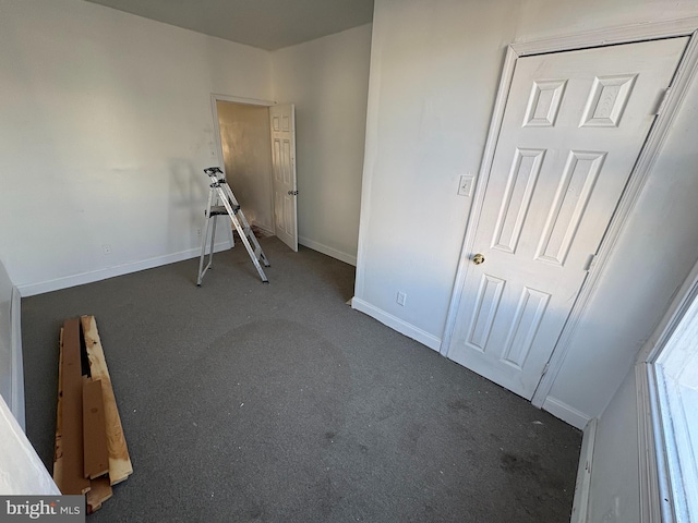 unfurnished bedroom featuring dark colored carpet