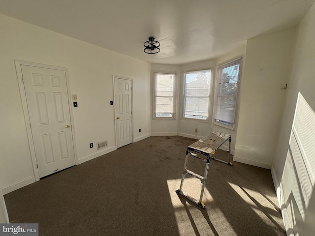 interior space featuring dark carpet