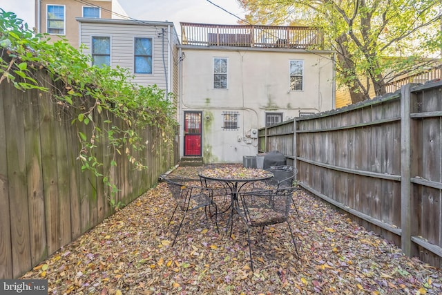 back of property featuring a balcony