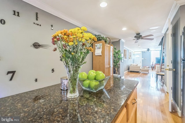 kitchen featuring ceiling fan, crown molding, and light hardwood / wood-style flooring