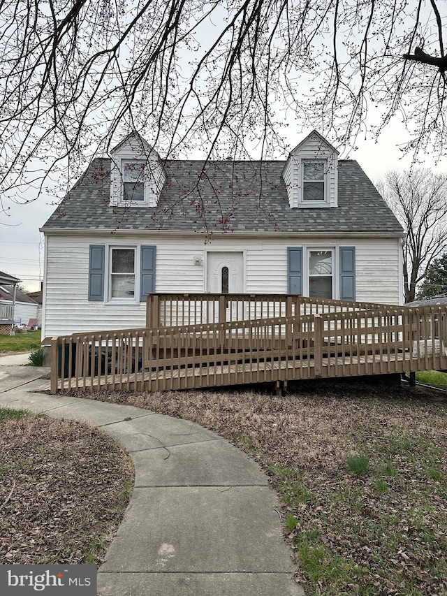 cape cod house featuring a deck