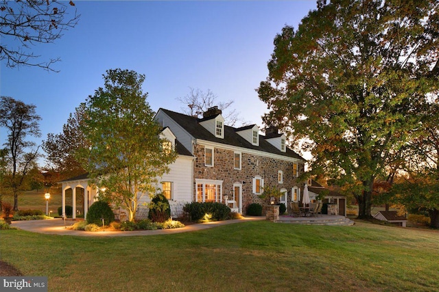 view of front facade featuring a yard and a patio area