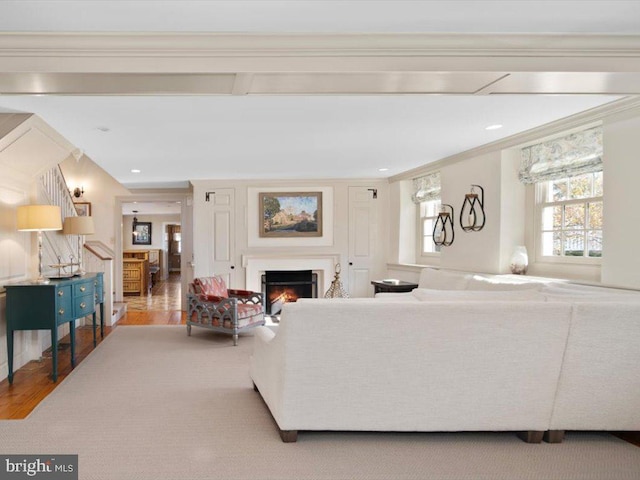 living room featuring ornamental molding and light hardwood / wood-style flooring