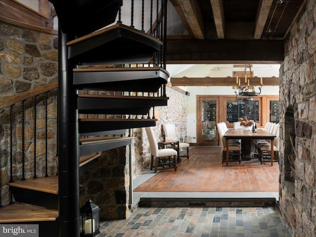 interior space featuring beamed ceiling and an inviting chandelier