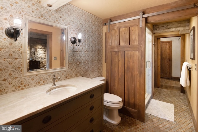 bathroom with toilet, vanity, and tile patterned floors