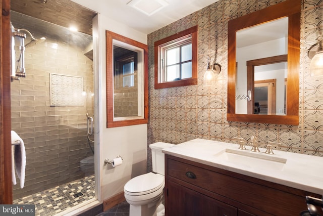 bathroom with tasteful backsplash, tile walls, vanity, an enclosed shower, and toilet