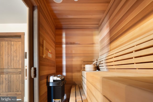 view of sauna / steam room with wood walls and wooden ceiling