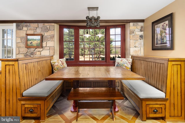 dining space featuring breakfast area and an inviting chandelier