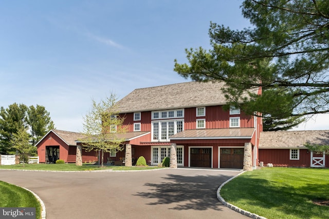 view of front of home featuring a garage and a front lawn