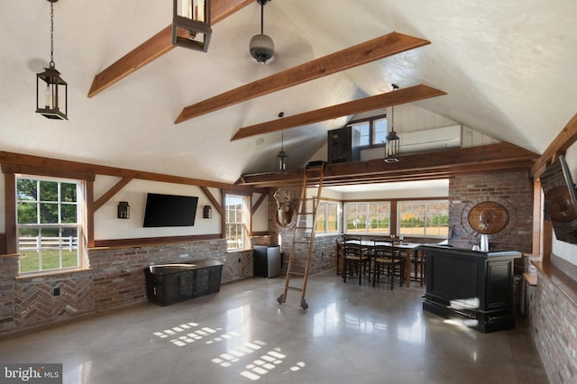 living room featuring high vaulted ceiling, brick wall, a healthy amount of sunlight, and beam ceiling