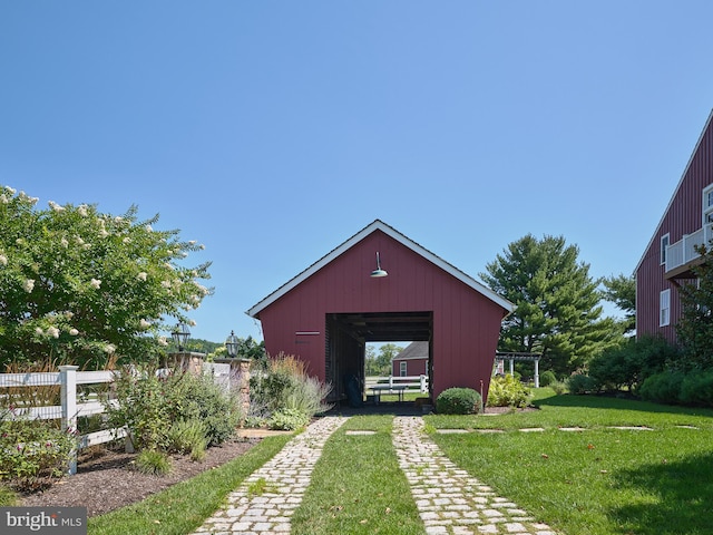 view of outbuilding with a yard