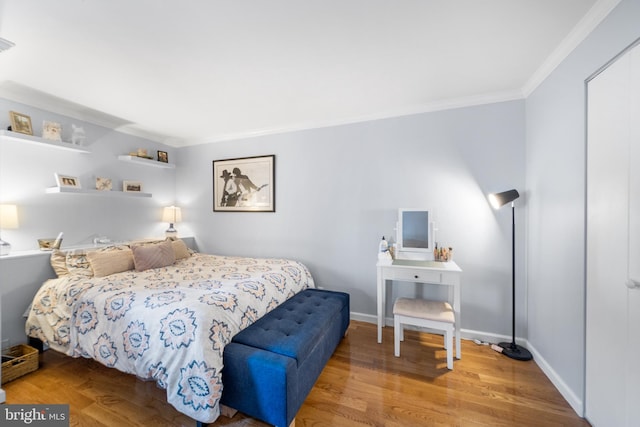 bedroom with crown molding and wood-type flooring