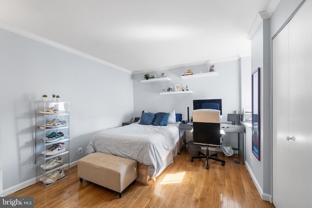 bedroom with a closet, crown molding, and hardwood / wood-style flooring