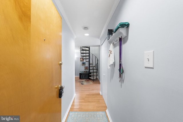 hallway featuring ornamental molding and hardwood / wood-style floors