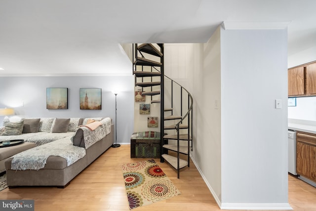 living room with ornamental molding and light wood-type flooring